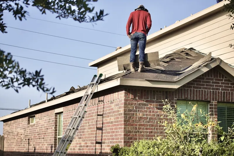 Professional roofer working on a residential roof in Brookdale Heights